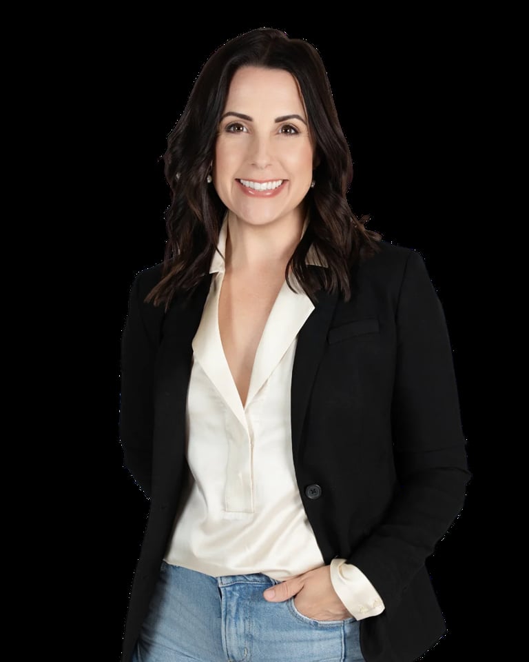 Professional headshot of a woman with long dark hair wearing a black blazer and white blouse against a black background
