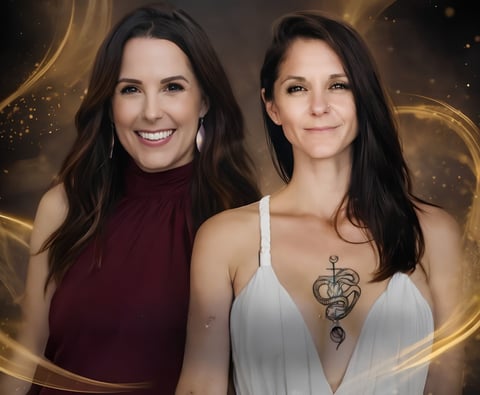 Two women smiling at camera against a shimmering golden bokeh background. One wears burgundy, the other white with a snake tattoo on her chest.