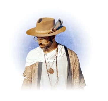 Man wearing tan cowboy hat, white shirt, and beige cardigan with feather and beaded necklace