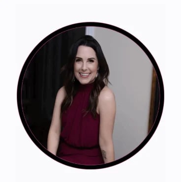 Portrait of a woman with dark hair wearing a burgundy sleeveless top, smiling at the camera in a circular frame